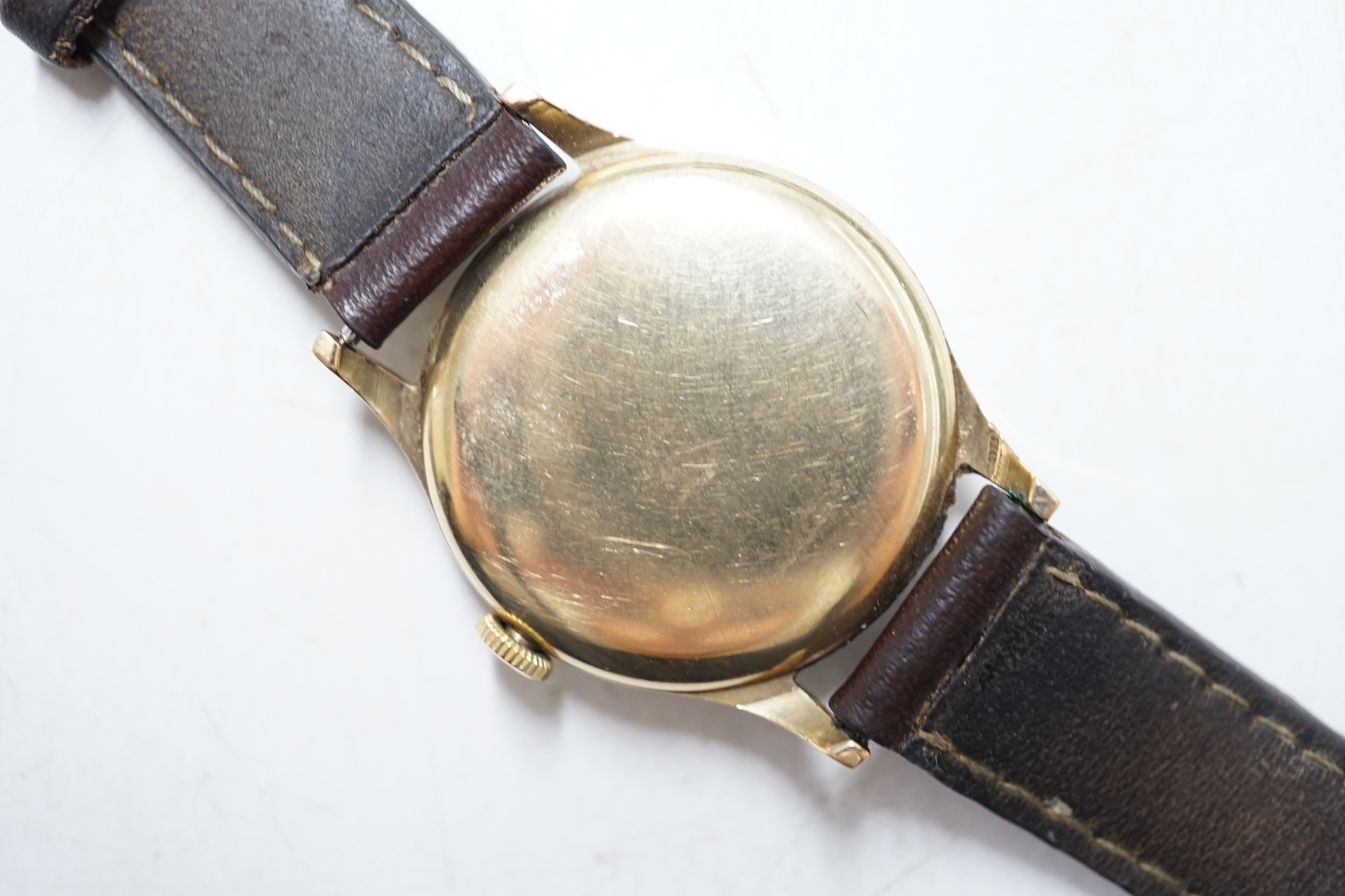 A gentleman's 9ct gold Ulysse Nardin manual wind wrist watch, with Arabic dial and subsidiary seconds, on associated leather strap. Condition - fair